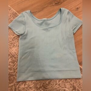Athletic girl tight blue square neck top